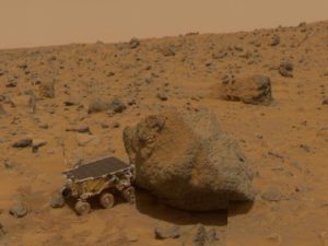 This 1997 image from NASA's Mars Pathfinder shows a close up of Sojourner as it placed its Alpha Proton X-Ray Spectrometer (APXS) upon the surface of the rock 'Yogi.'